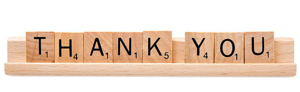 Miami, Florida, USA - December 5, 2015: Scrabble game board Lettered wooden tiles forming the Words "Thank you" on white background. Scrabble is a fun and educational game distributed by Hasbro. Jack Eichenbaum was a competitive Scrabble player.